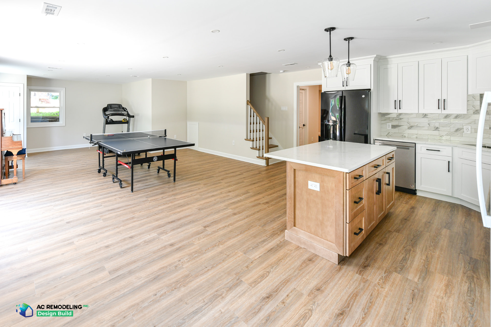 Open basement in-law suite great room with full kitchen, recreation area and wide-plank flooring