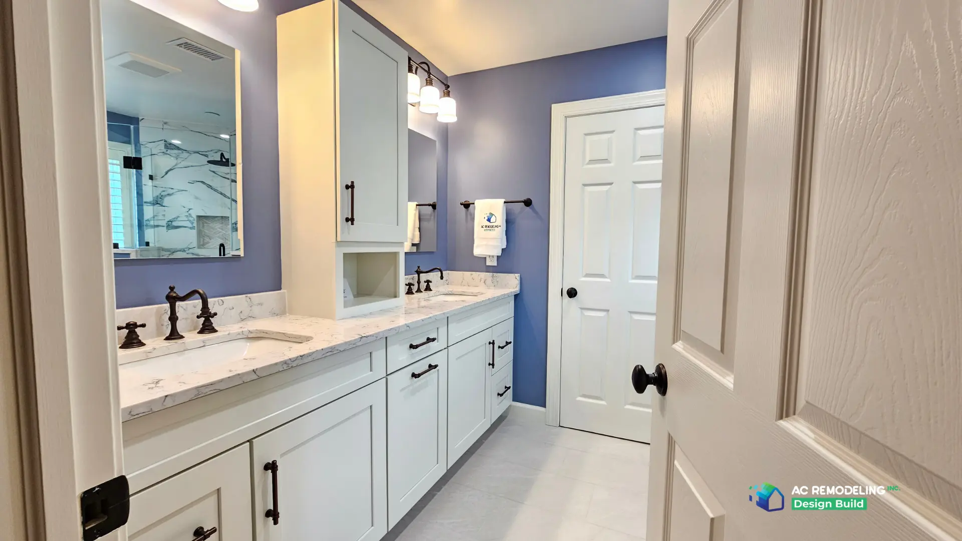 Galley view of the double vanity with tall storage tower and bronze bridge faucets