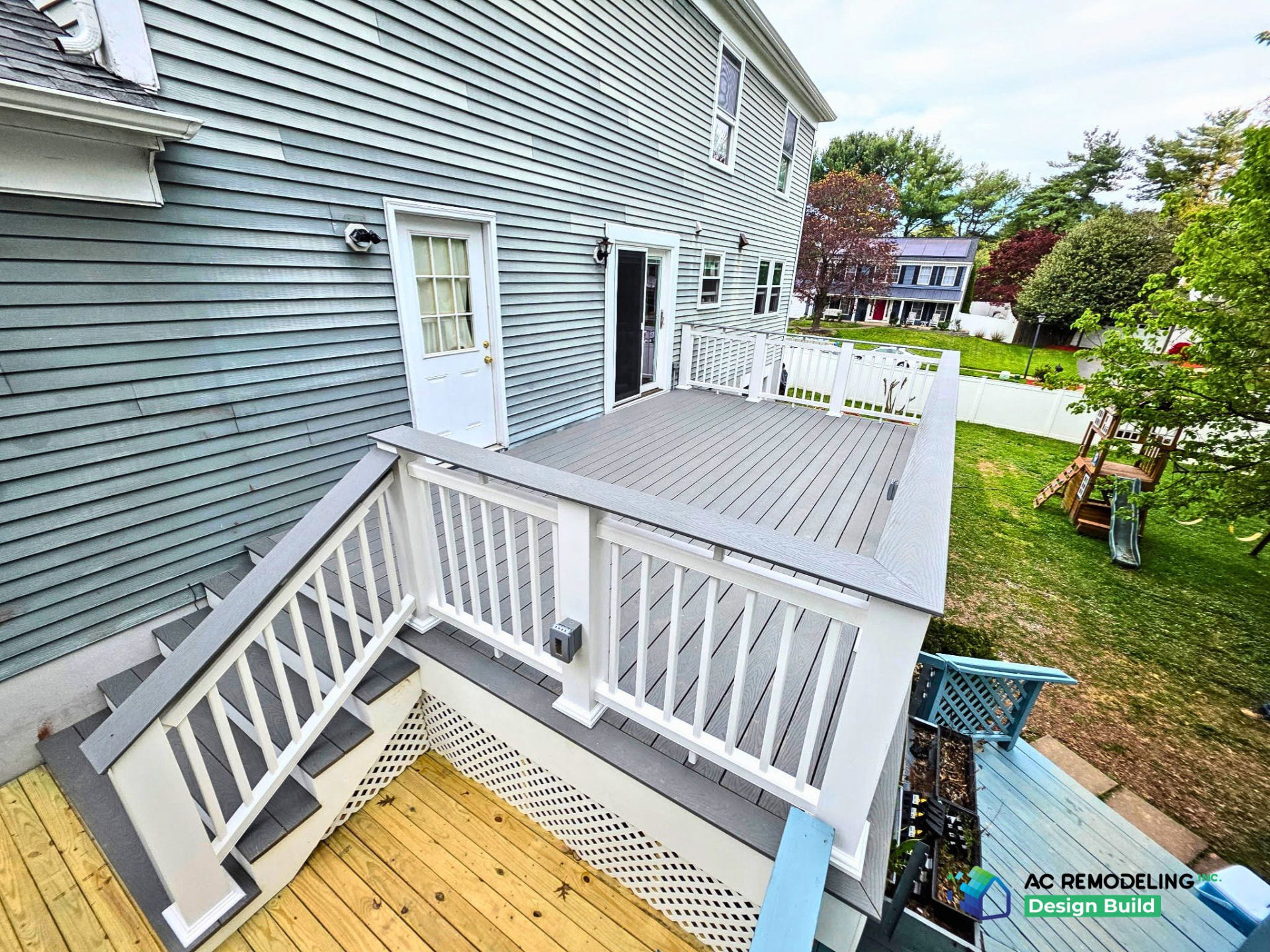 Aerial view of rebuilt deck with stairs and white railing