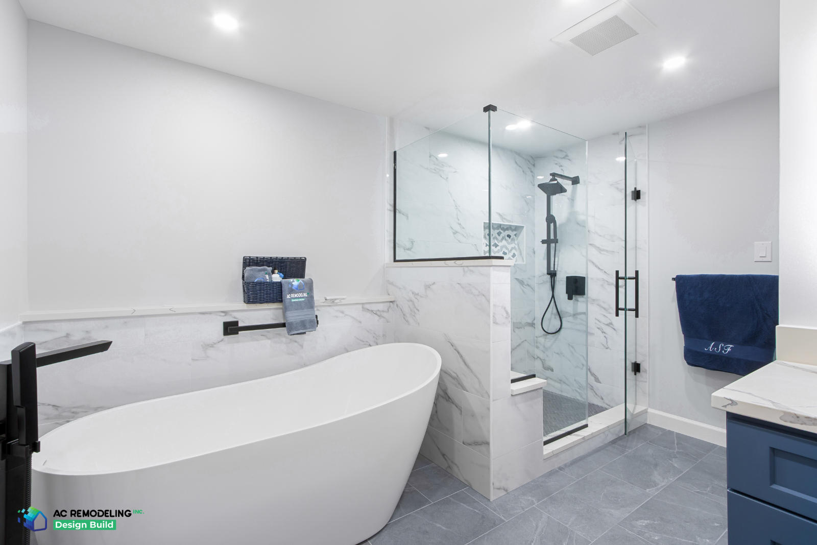 Primary bathroom with freestanding tub and a ceiling exhaust fan placed just outside the glass shower
