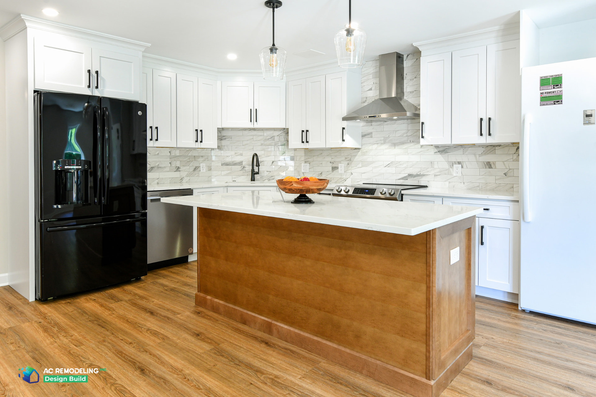 Finished in-law suite basement kitchen in Rockville MD with white shaker cabinetry, wood island and quartz countertop
