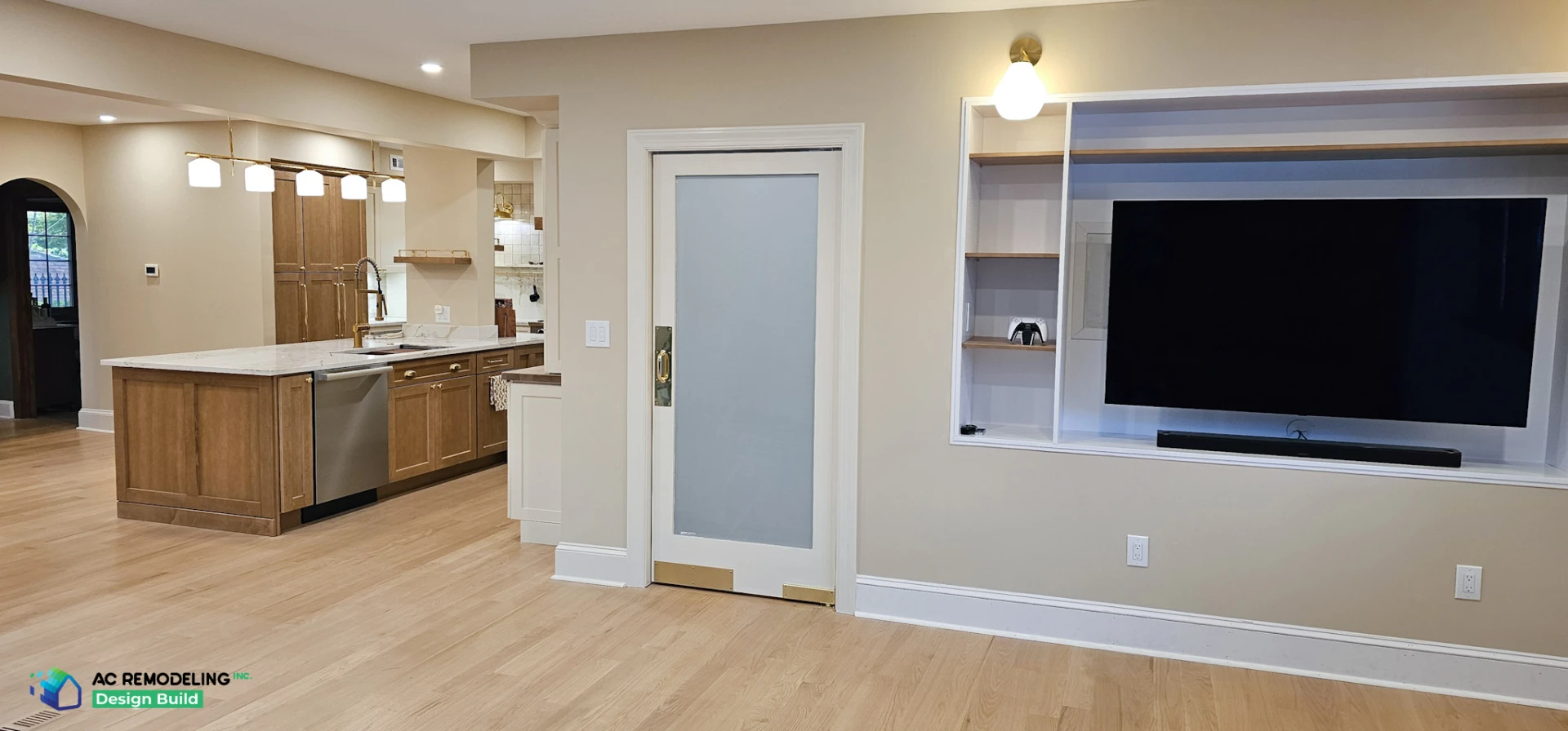 Family room built-in media wall beside a frosted glass pantry door