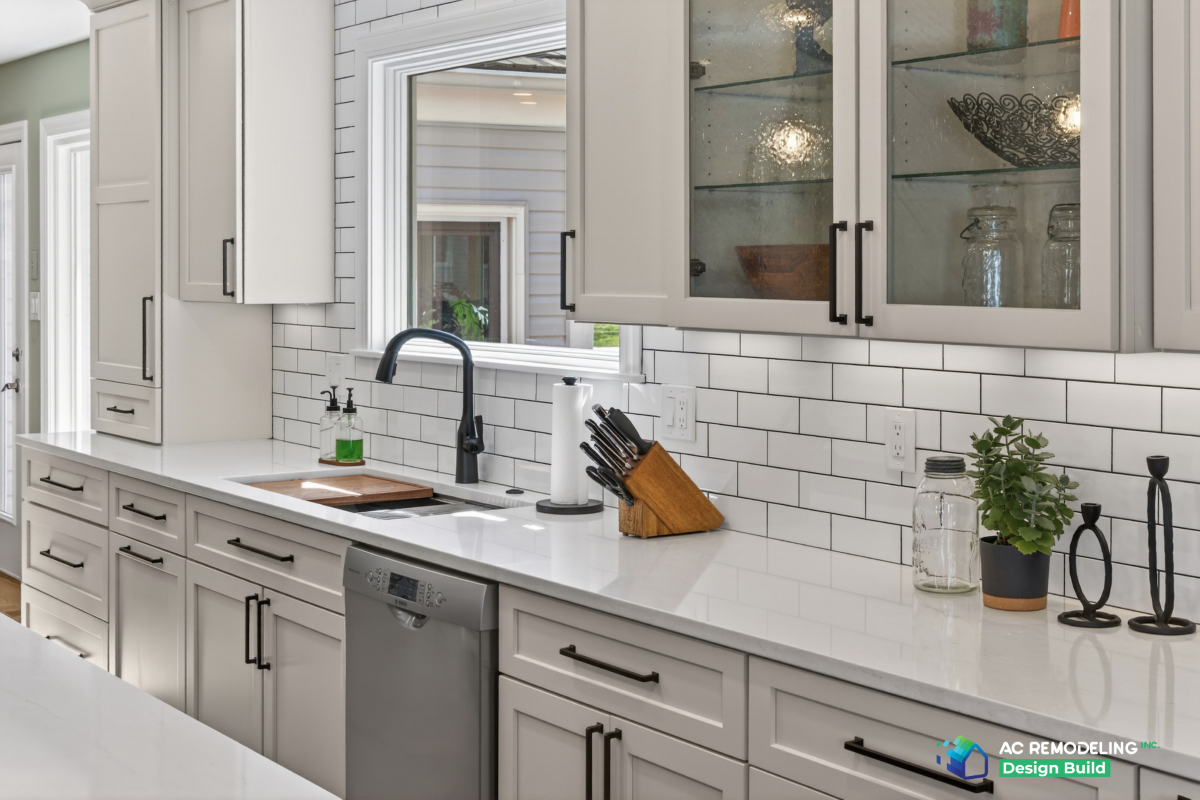 Sink run with seeded-glass upper cabinets, matte black faucet and quartz counters