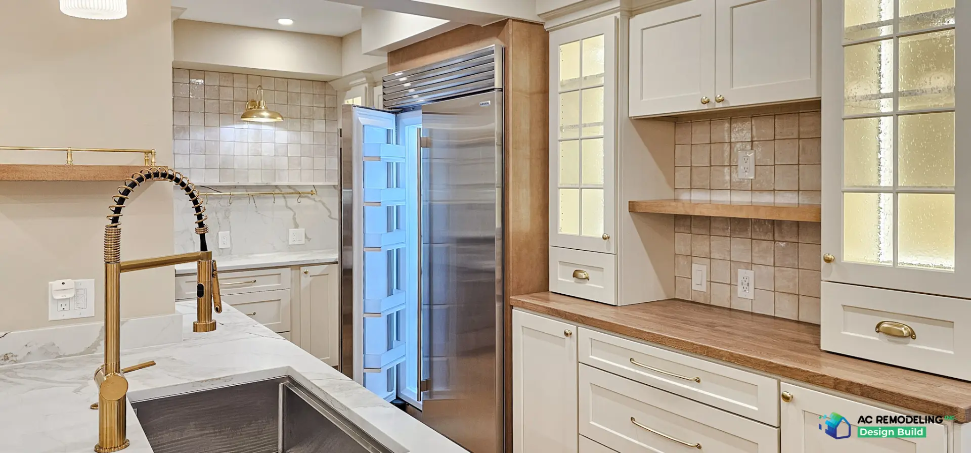 Refrigerator column with lit glass cabinets and butcher block hutch counter