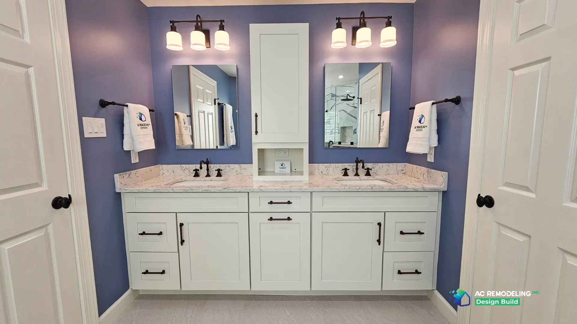 Symmetrical double vanity with paired mirrors, sconces and center storage tower