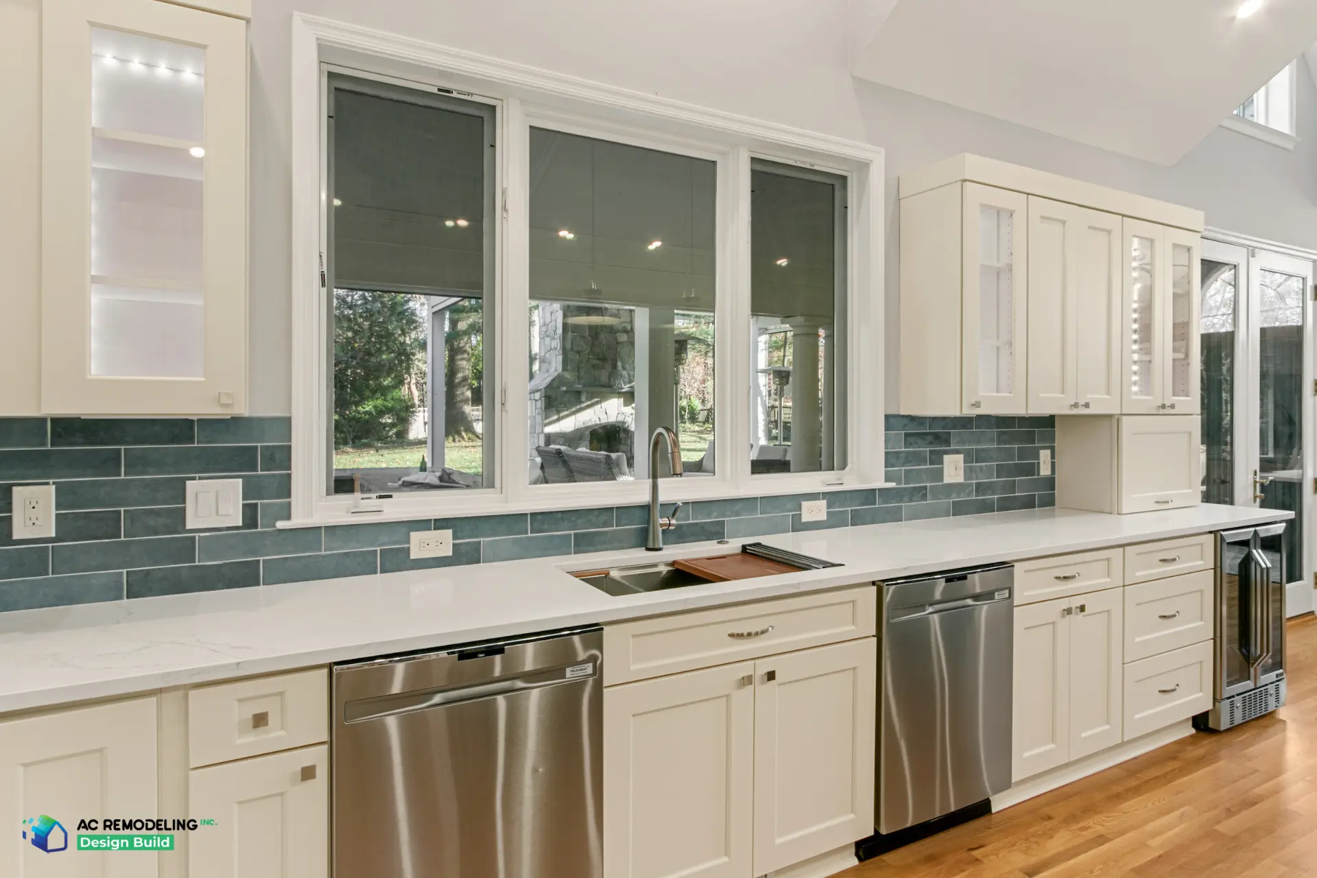 Long window sink run with blue-green tile, dual dishwashers and beverage fridge