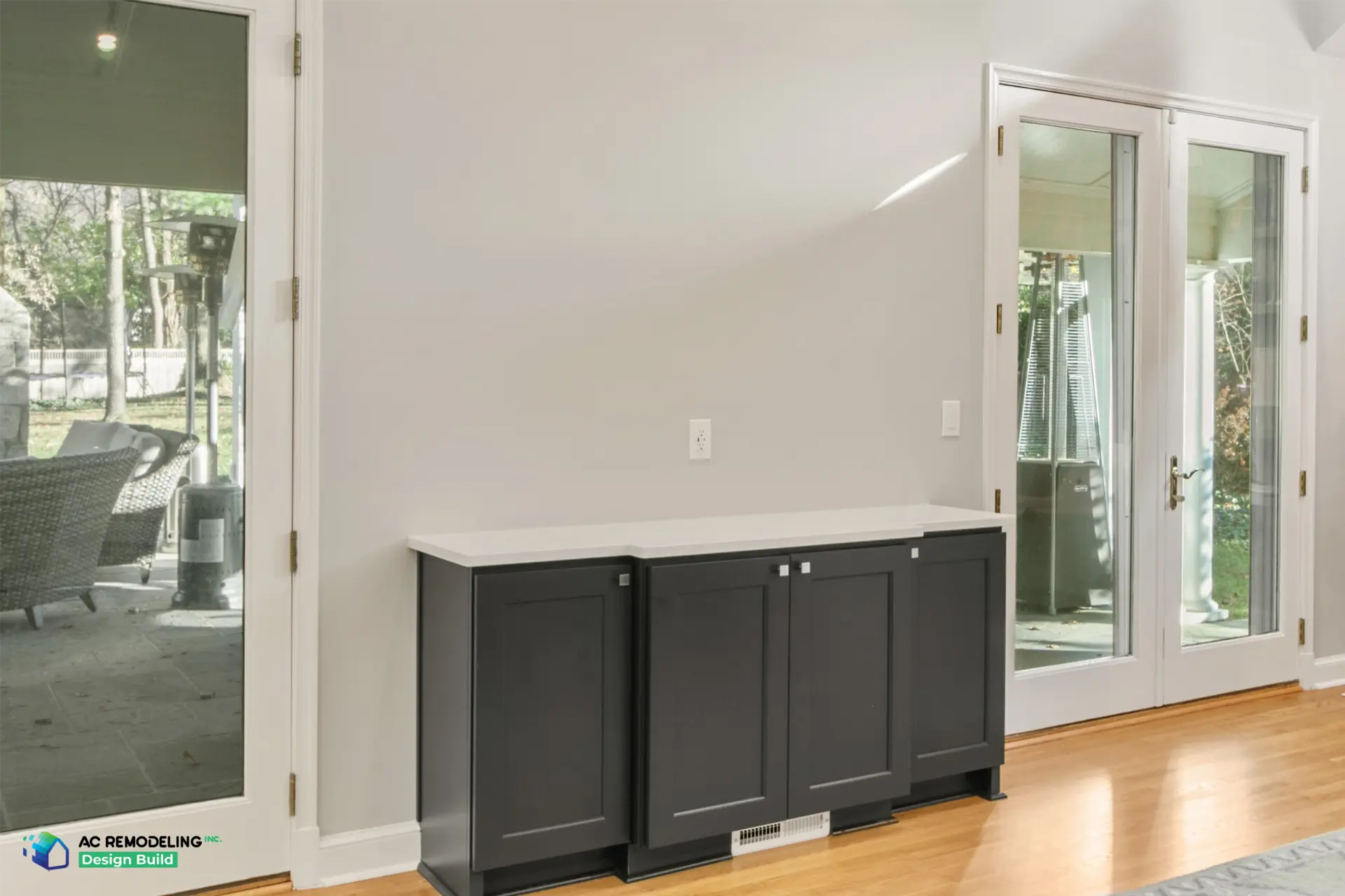 Charcoal buffet cabinet with quartz top between the French doors to the patio