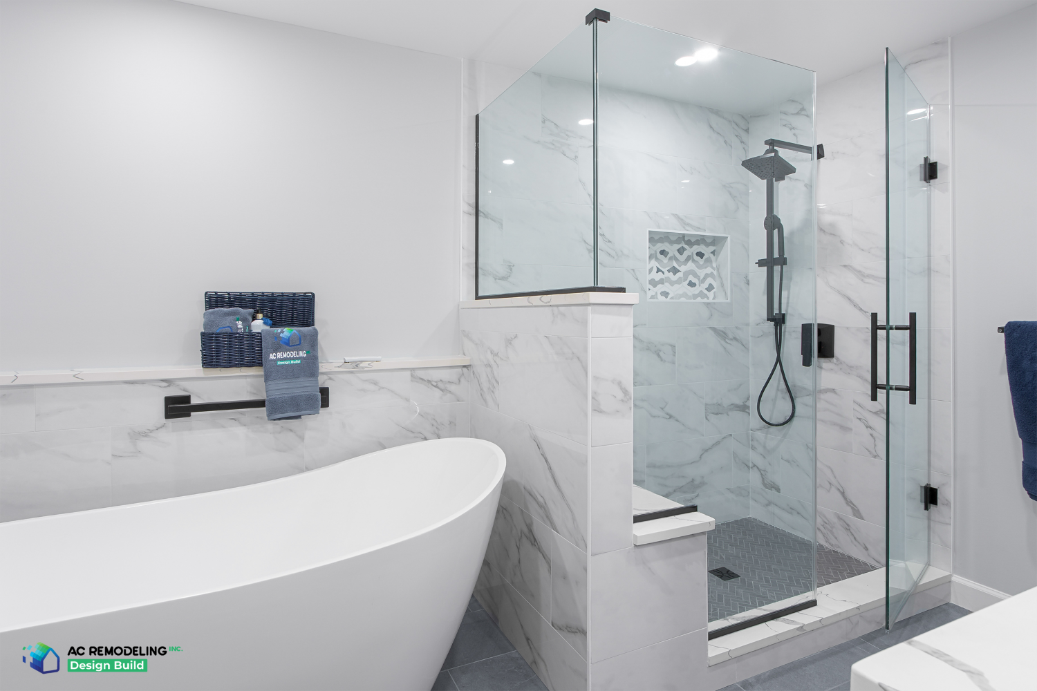 Freestanding tub beside marble-tiled walk-in shower with herringbone floor