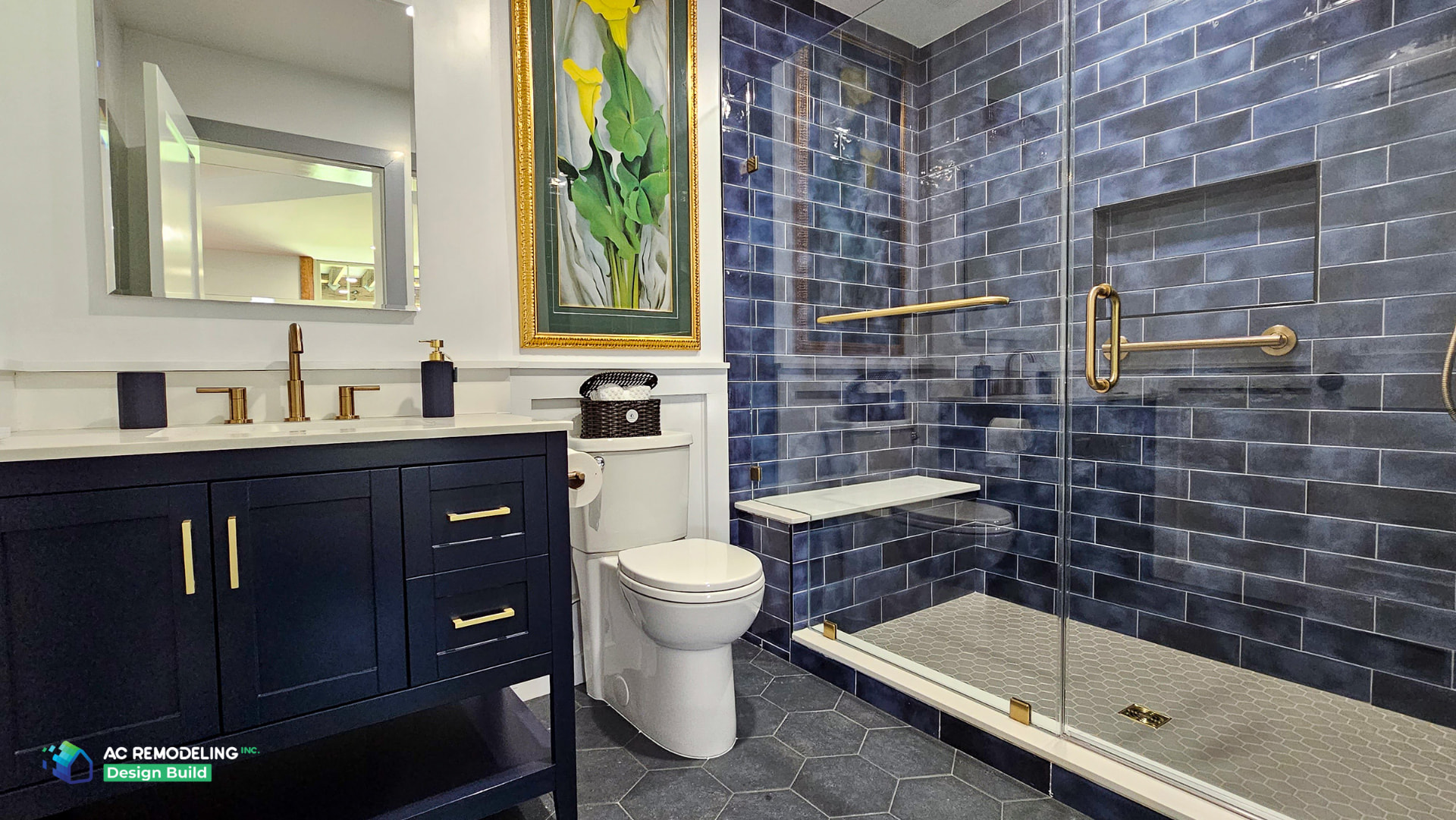 Basement bathroom with navy vanity, brass fixtures and blue glazed subway tile shower