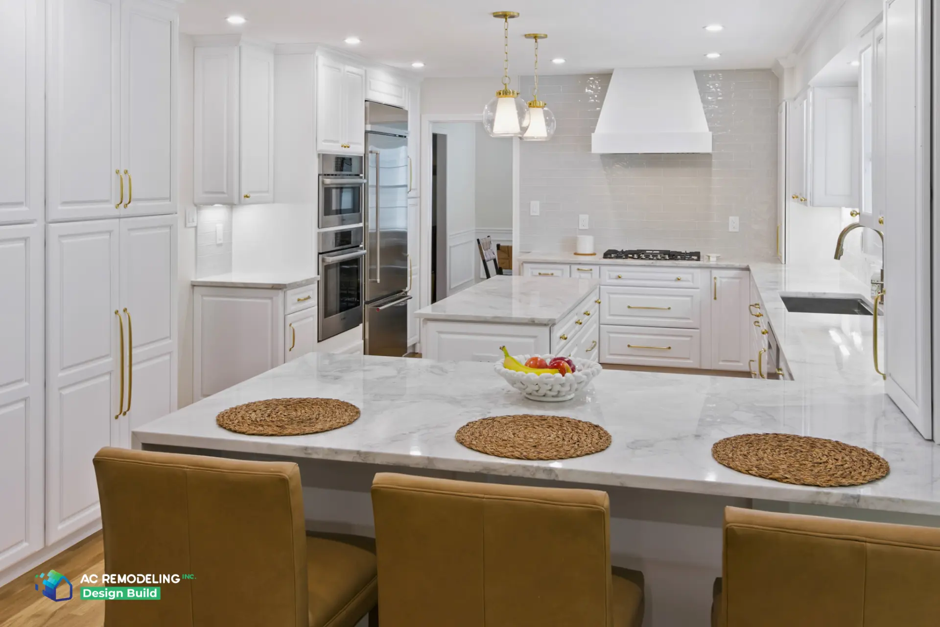 Kitchen with glass pendants, paneled refrigerator and marble waterfall counter