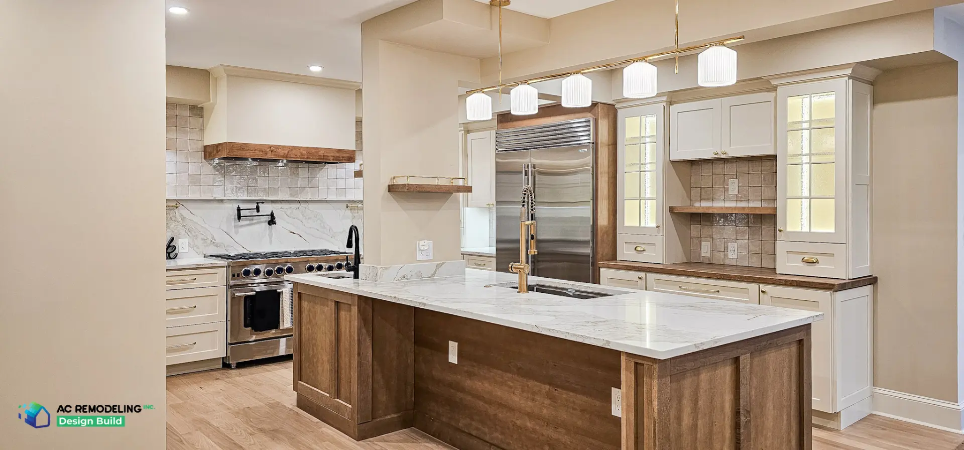Open kitchen with fluted glass pendants over the stained quartzite island
