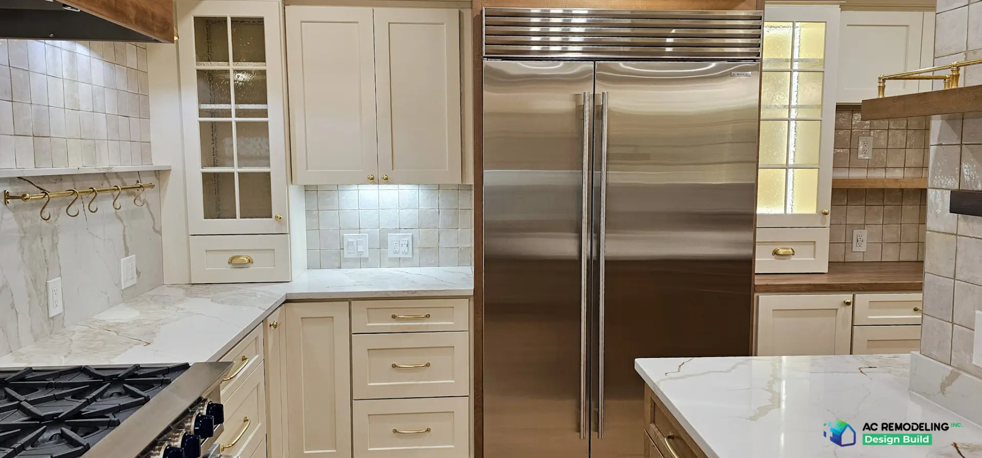 Cream shaker cabinetry with brass hardware and built-in Sub-Zero refrigerator