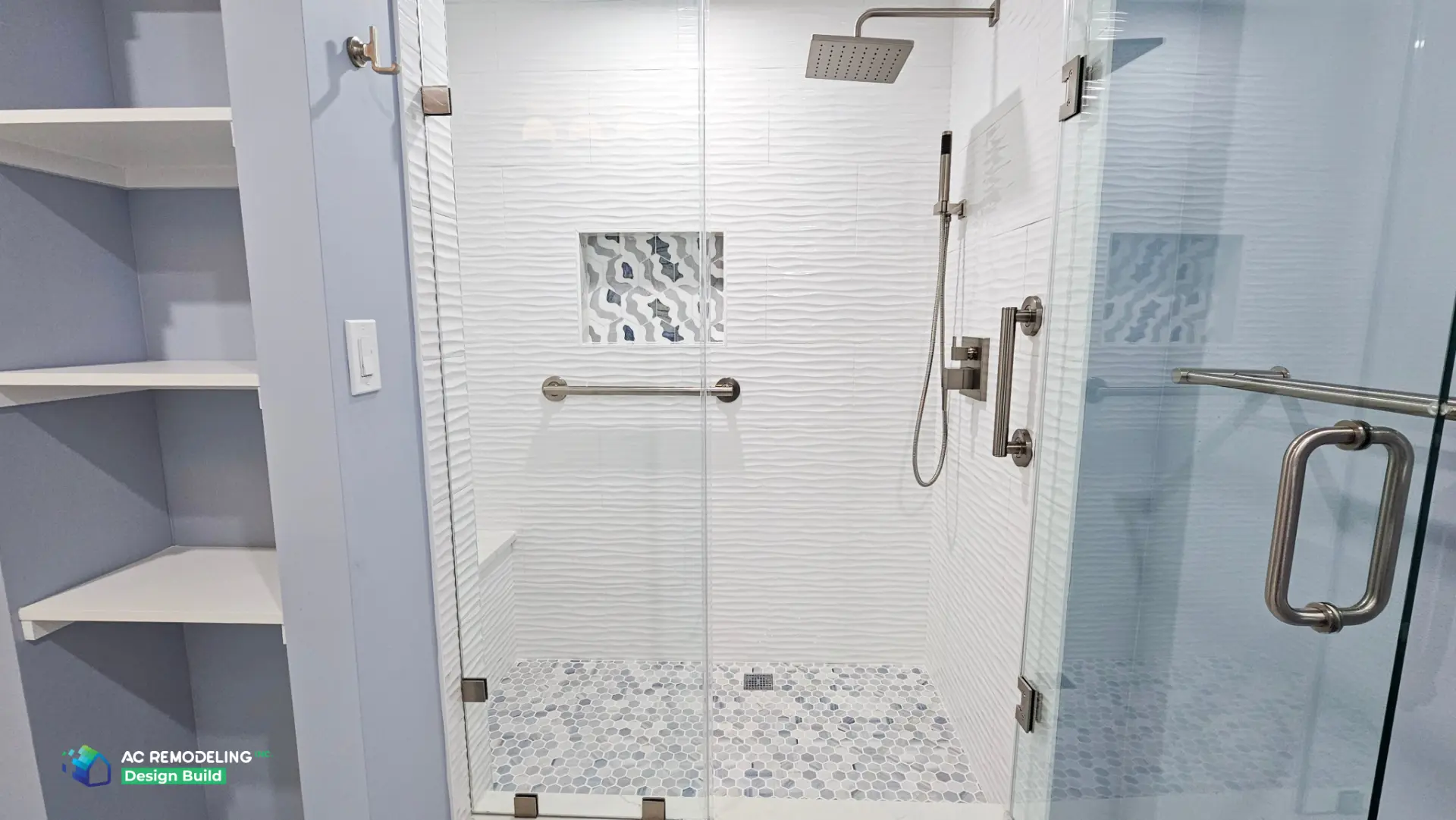 Shower interior with square rain head, handheld sprayer, decorative niche and hex mosaic floor