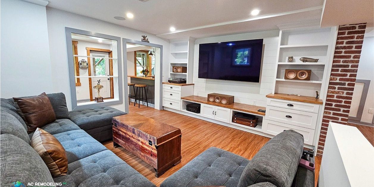 Finished basement lounge with wet bar, linear fireplace and warm wood millwork
