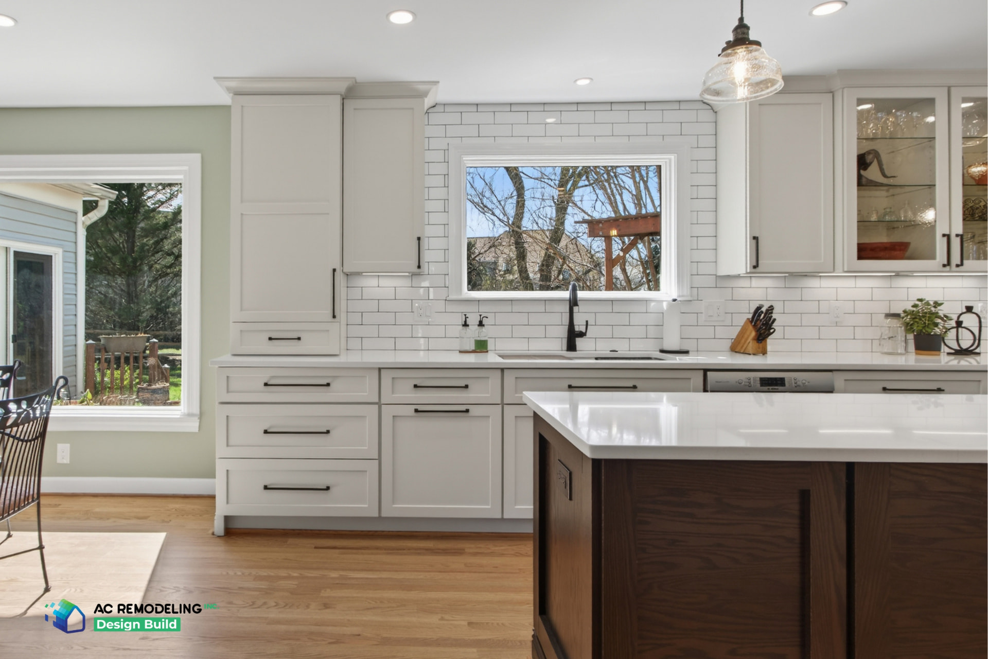 White shaker kitchen with subway tile backsplash and dark wood island