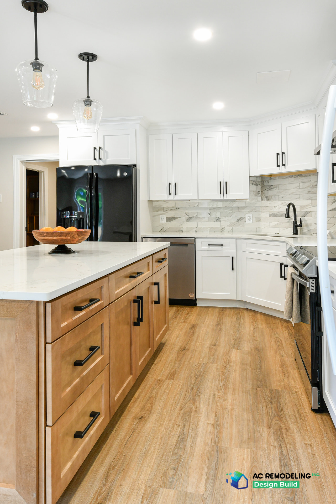 In-law suite kitchen with stained wood island cabinetry, matte black hardware and white perimeter cabinets