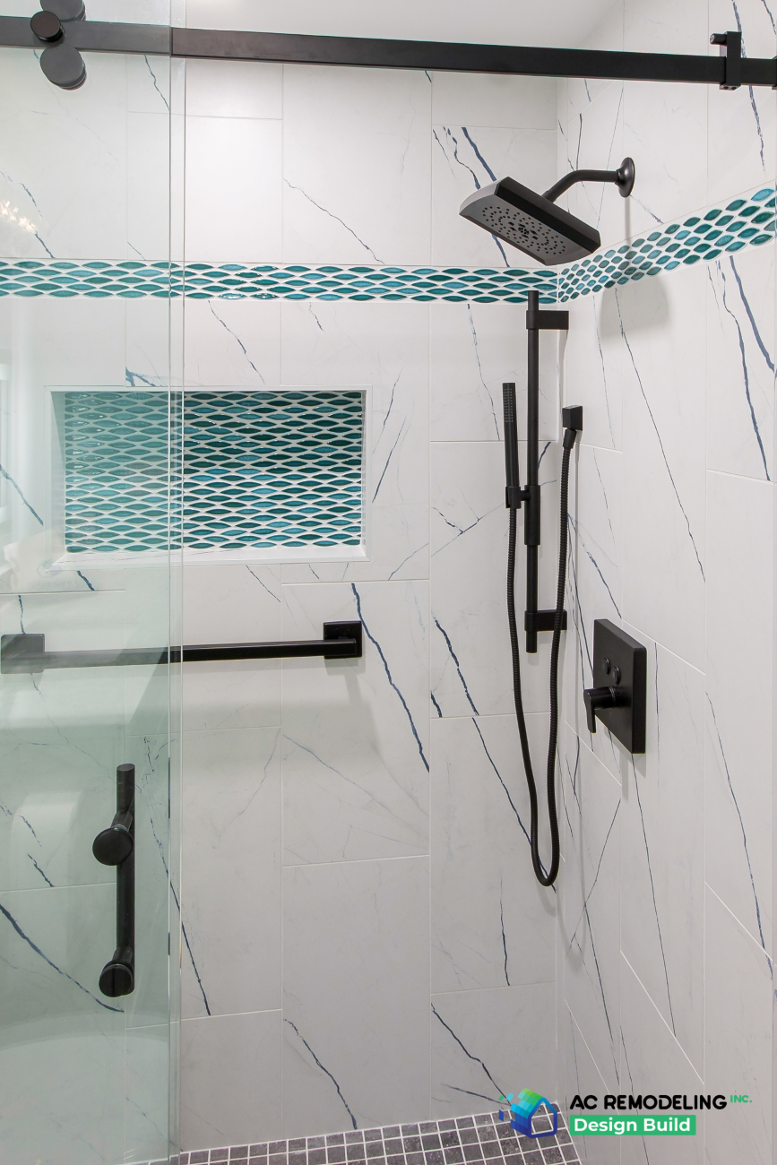 Marble-look shower with teal glass mosaic band, niche and matte black fixtures
