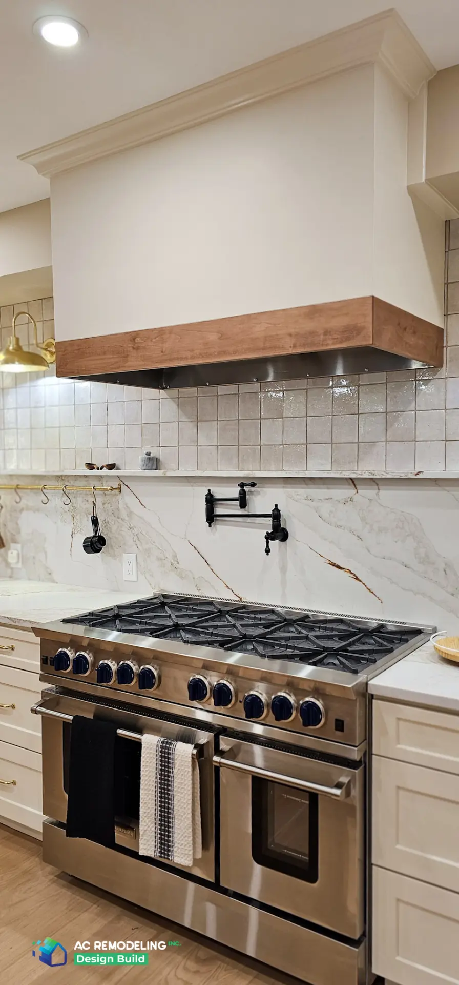 Pro gas range with black pot filler and mitered quartzite backsplash