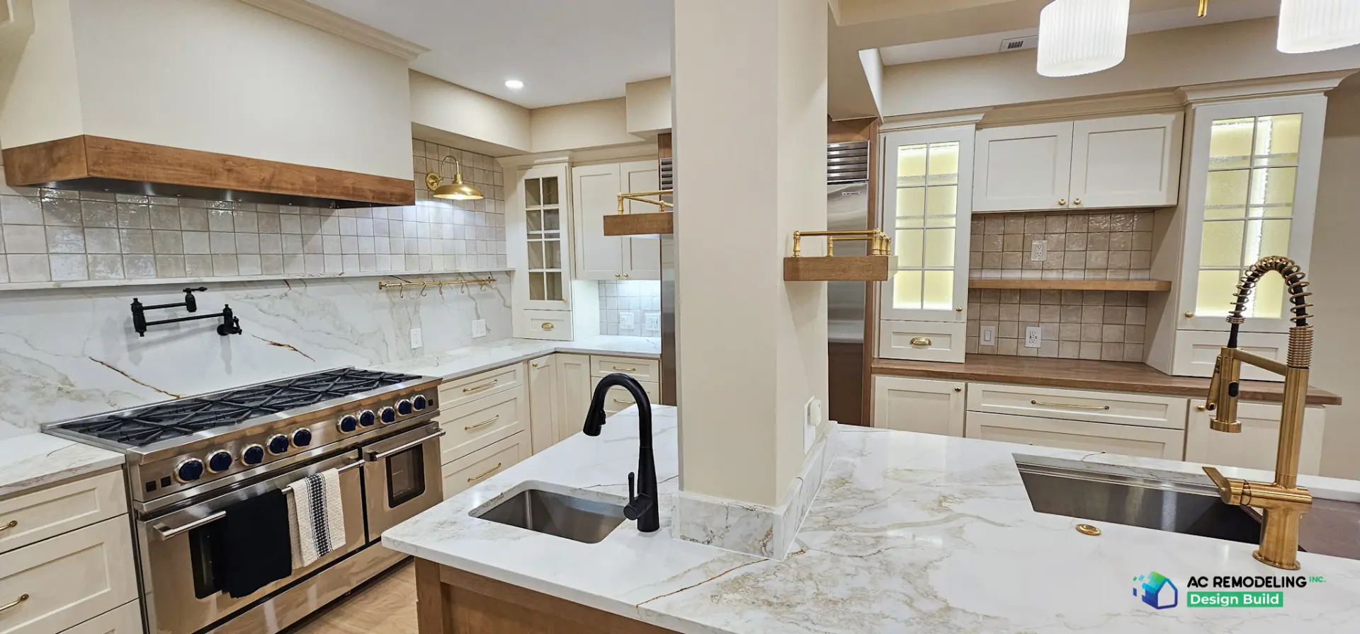 Double-basin island layout with tiled column and brass floating shelf brackets