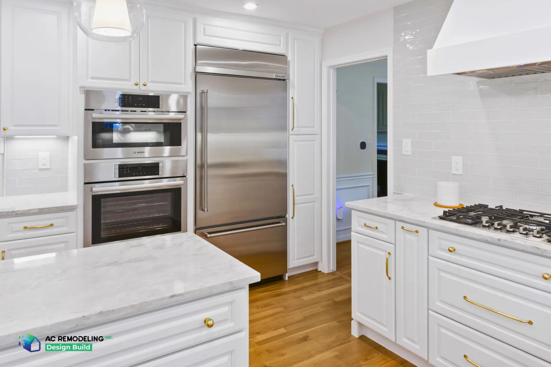 Paneled refrigerator, Bosch wall ovens and gas cooktop with subway backsplash