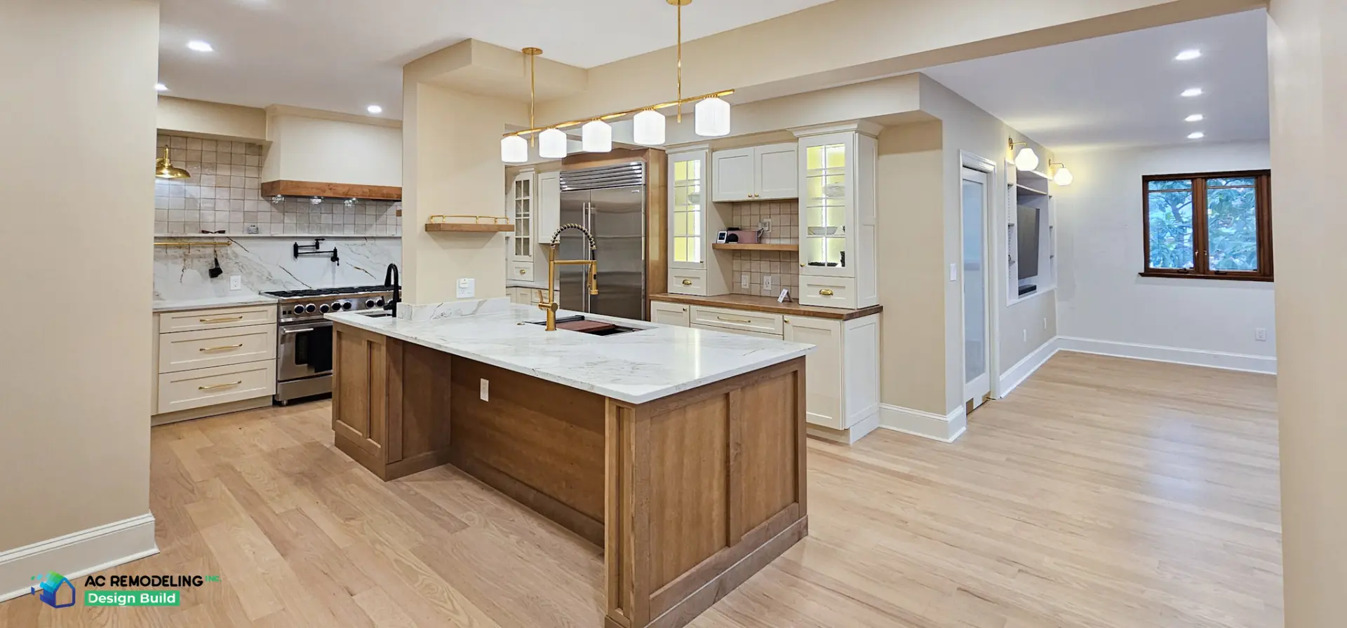 Full open-plan view of the renovated kitchen with quartzite island and pantry wall