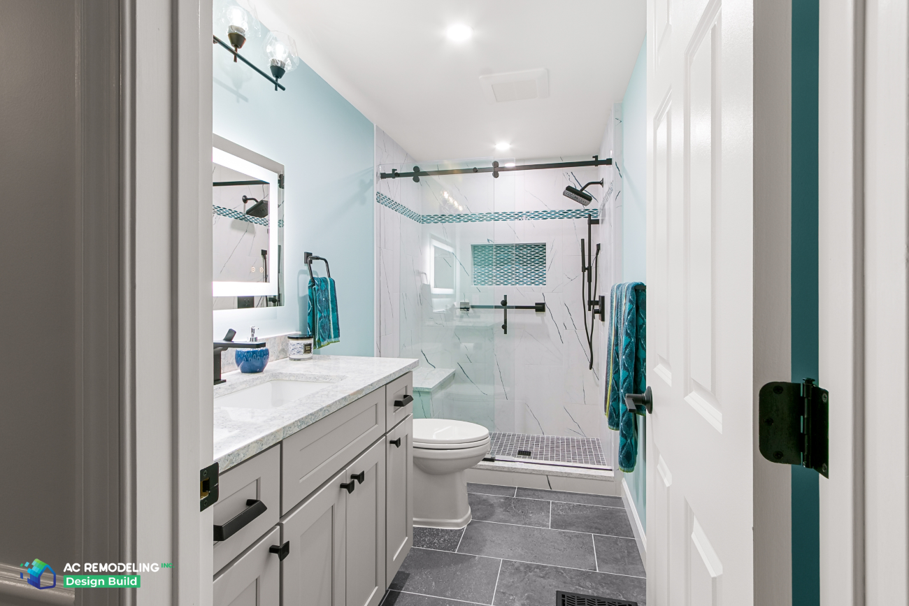 Full hall bath view from doorway with vanity, toilet and walk-in glass shower