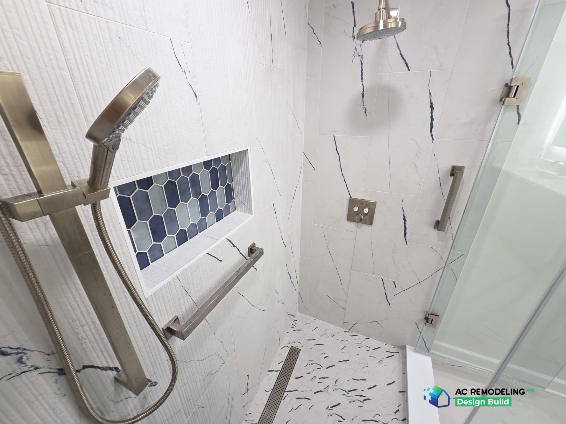 Detail of the hand shower, grab bar and blue picket-tile niche